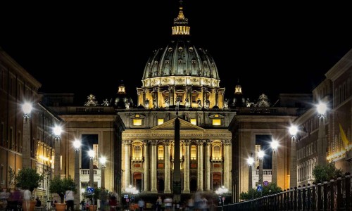 Saint Peter Basilica in Vatican City at Rome, Italy and Street Via della Conciliazione at night.